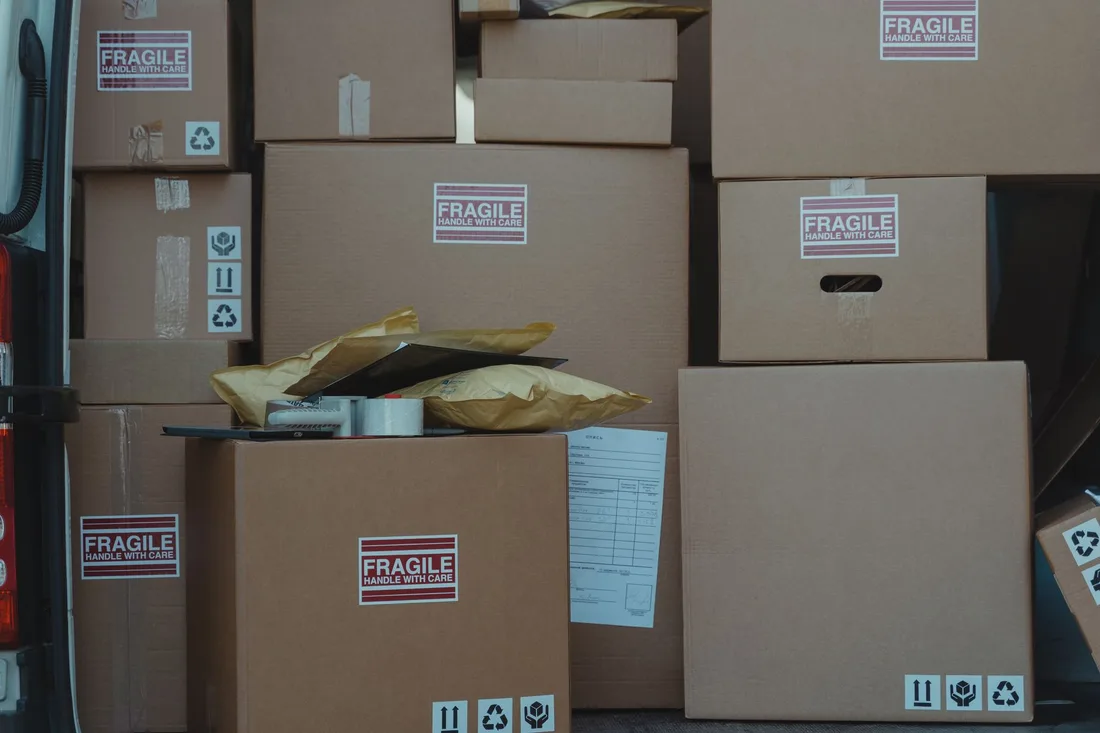 A variety of cardboard boxes labeled 'fragile' stacked in a vehicle for shipping or storage.. Photo by Tima Miroshnichenko on Pexels