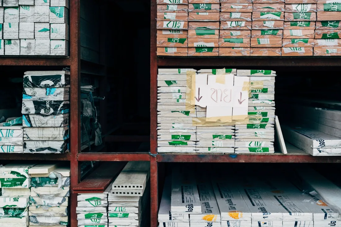 Image of a warehouse showcasing organized stacks of building materials on shelves.. Photo by Markus Winkler on Pexels
