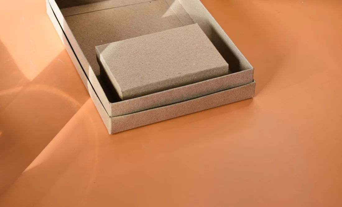 Close-up of a cardboard box on an orange surface, ideal for packaging themes.. Photo by Harper Sunday on Pexels
