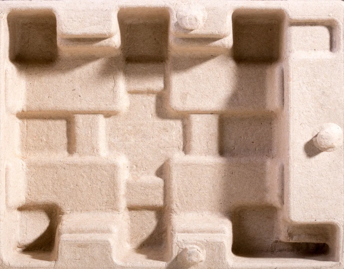 Detailed overhead view of textured cardboard packaging insert for protection.. Photo by Valentin Ivantsov on Pexels