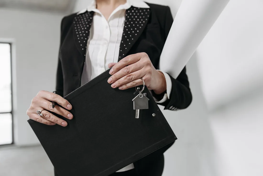 Agent holding a folder and house keys ready to hand over after closing. Photo by Pavel Danilyuk on Pexels