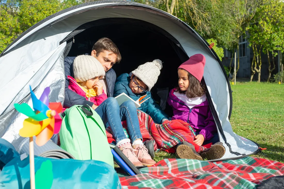 Family relaxing together in a tent at a campsite. Photo by Kampus Production on Pexels