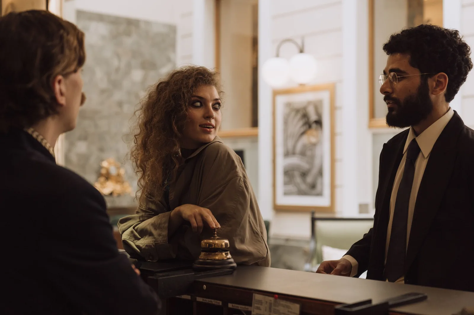 Guests interacting at a luxurious hotel reception desk, emphasizing hospitality and service. Photo by cottonbro studio on Pexels