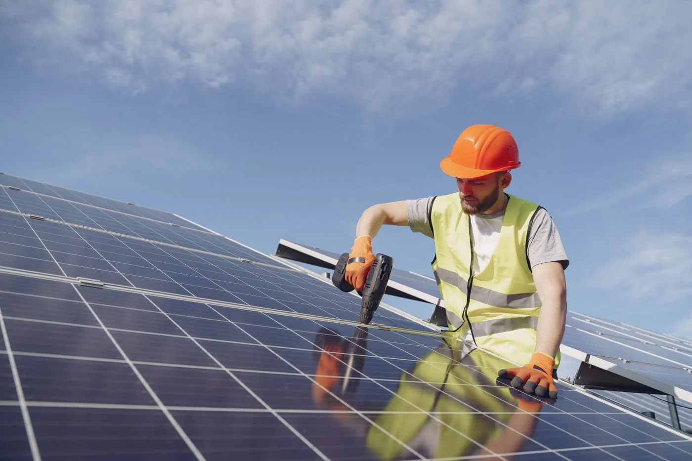 Energy Audits and Efficiency — Technician installing solar panels with a power tool on a roof. Photo by Gustavo Fring on Pexels