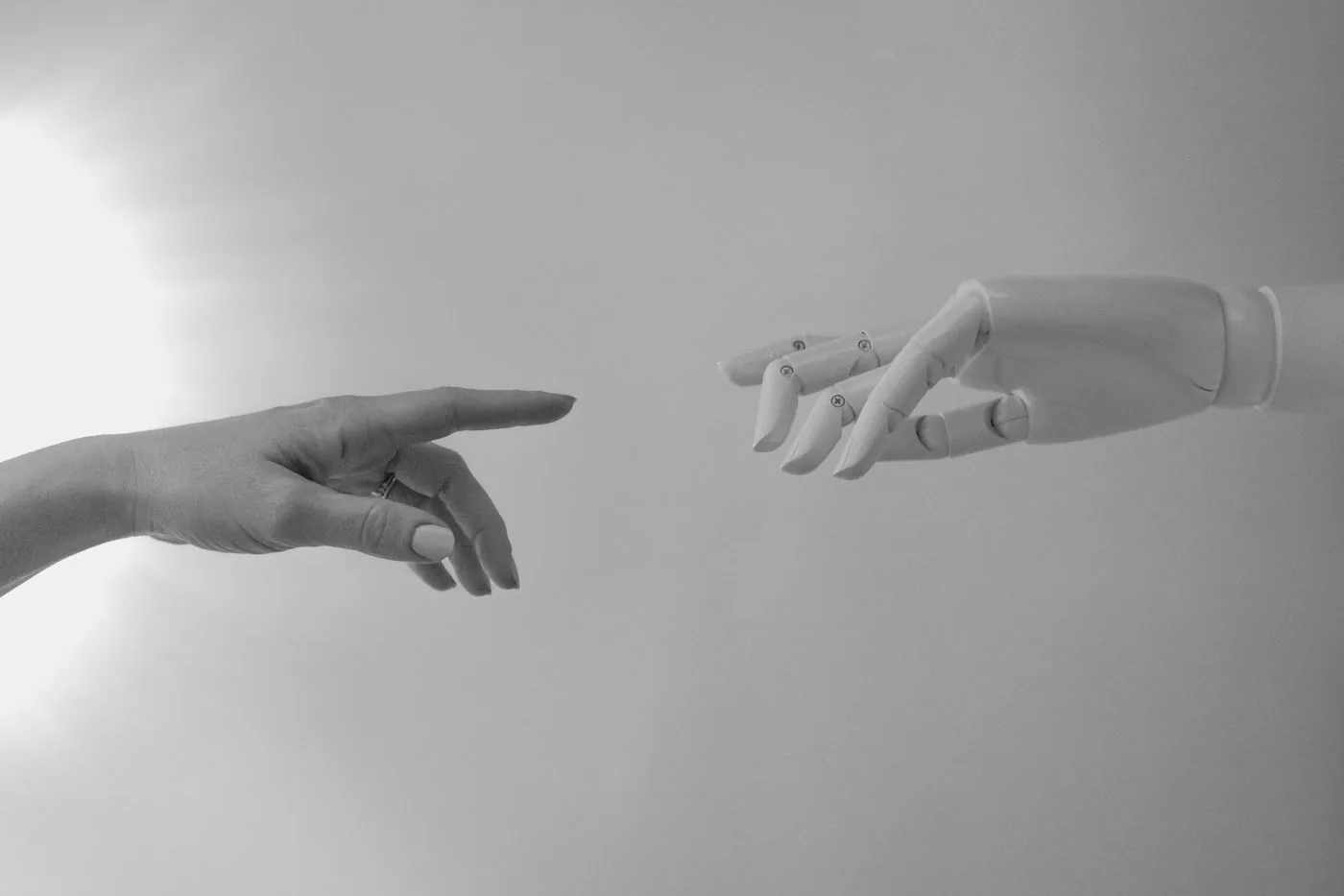 Human and robot hands meeting representing controlled AI crawler access. Photo by Tara Winstead on Pexels