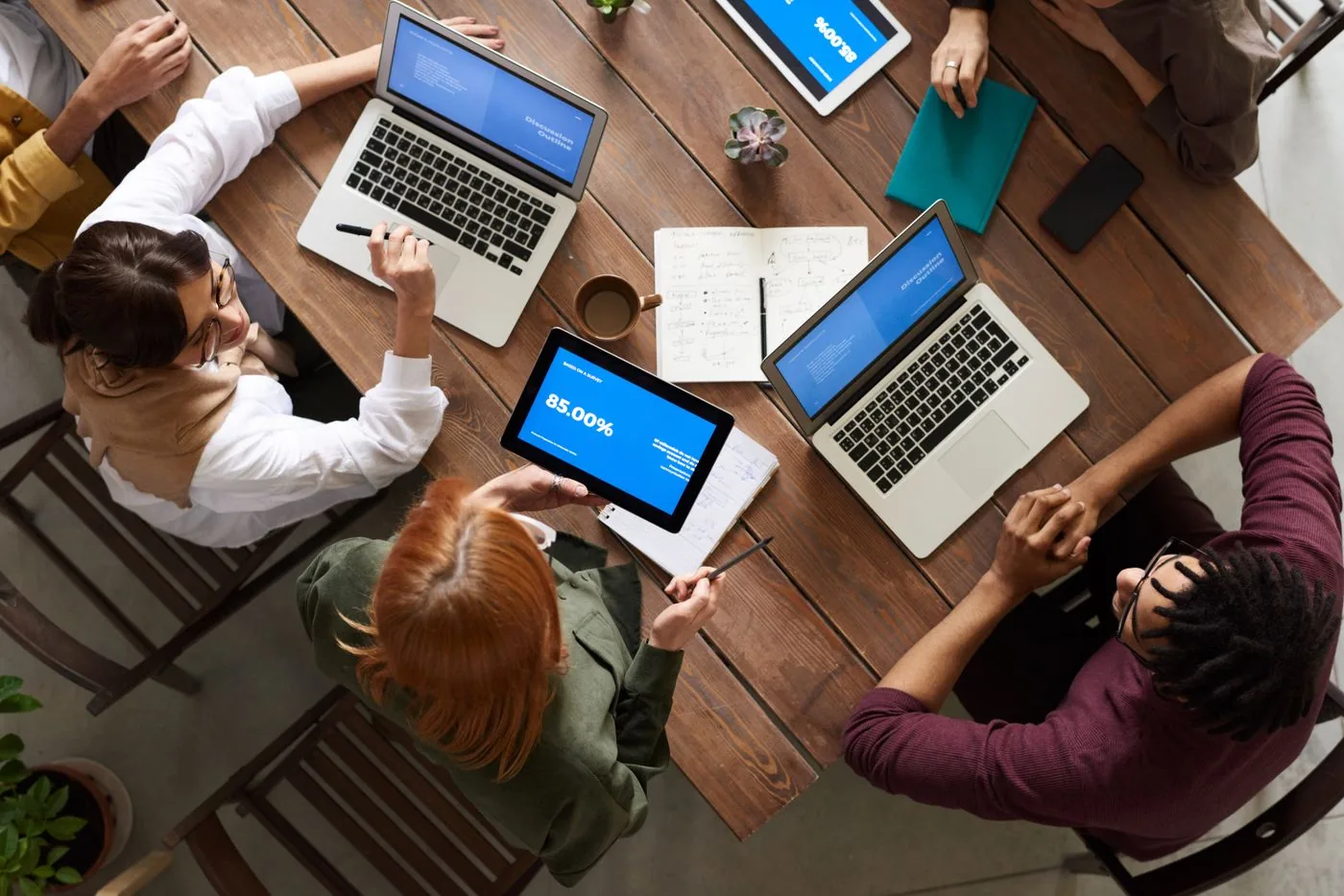 Marketing team planning paid search campaign structure on laptops. Photo by fauxels on Pexels
